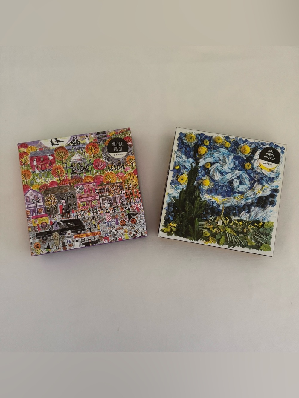 Two 500-piece Galison puzzles. EUC. "Halloween Parade" & "Starry Night Petals".
